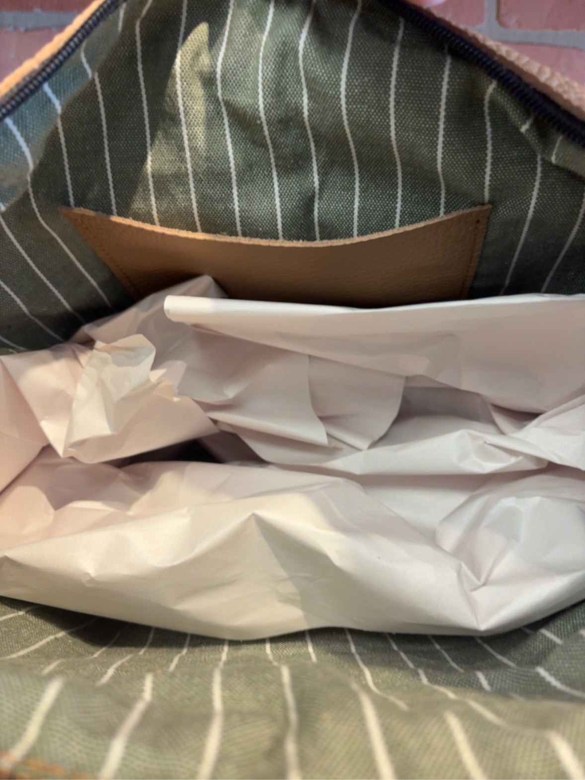 Honey Floral KC bag interior showing green-and-cream striped lining and one tan interior pocket.
