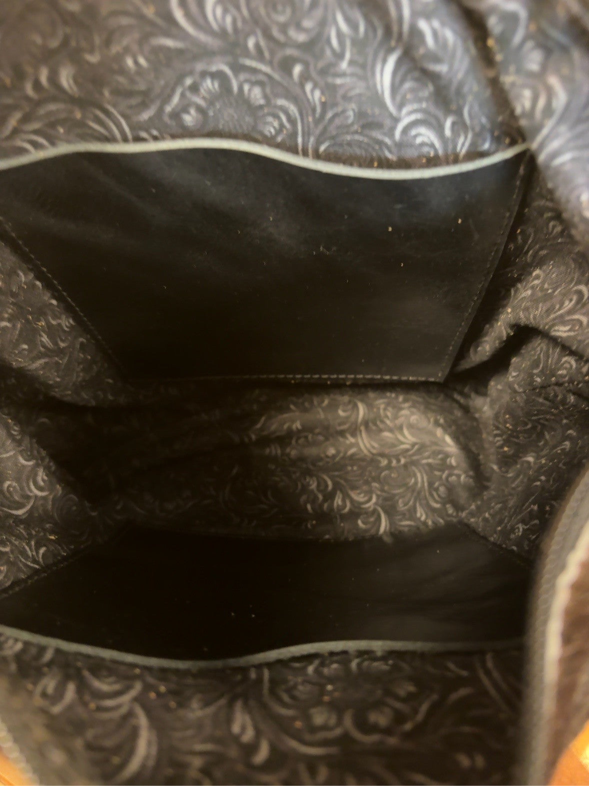 Patterned interior of the El Paso goat hide bag showing two black inside pockets.