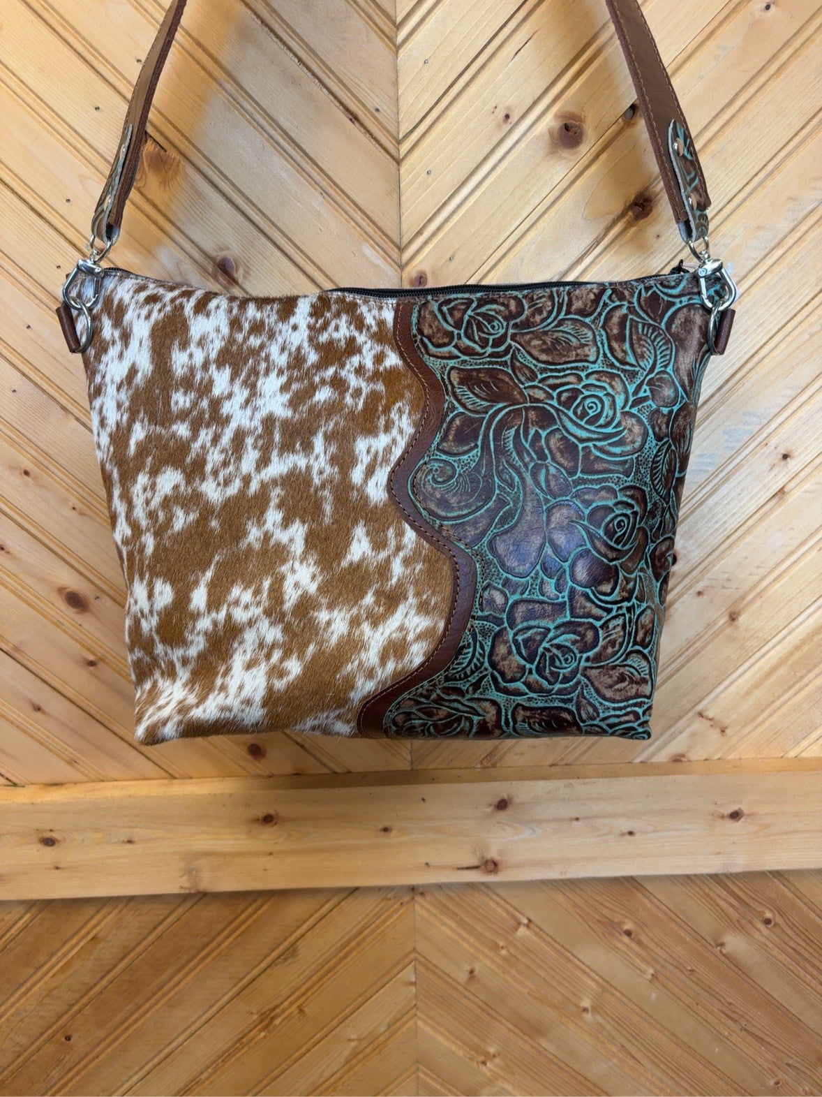 Front of KC bag with brown-and-white cowhide and turquoise floral embossed leather