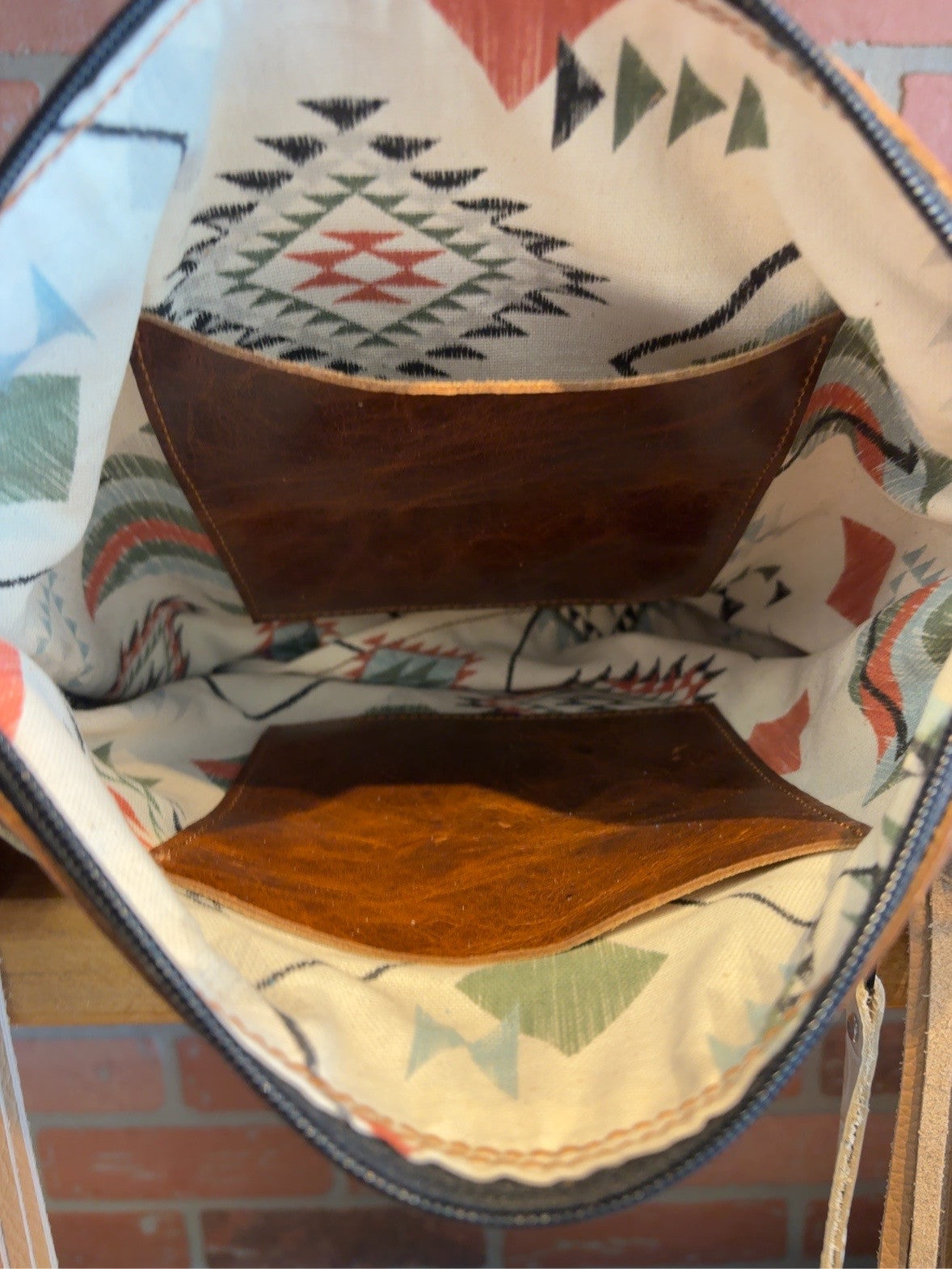 Interior of the El Paso bag showing patterned lining and two brown pockets