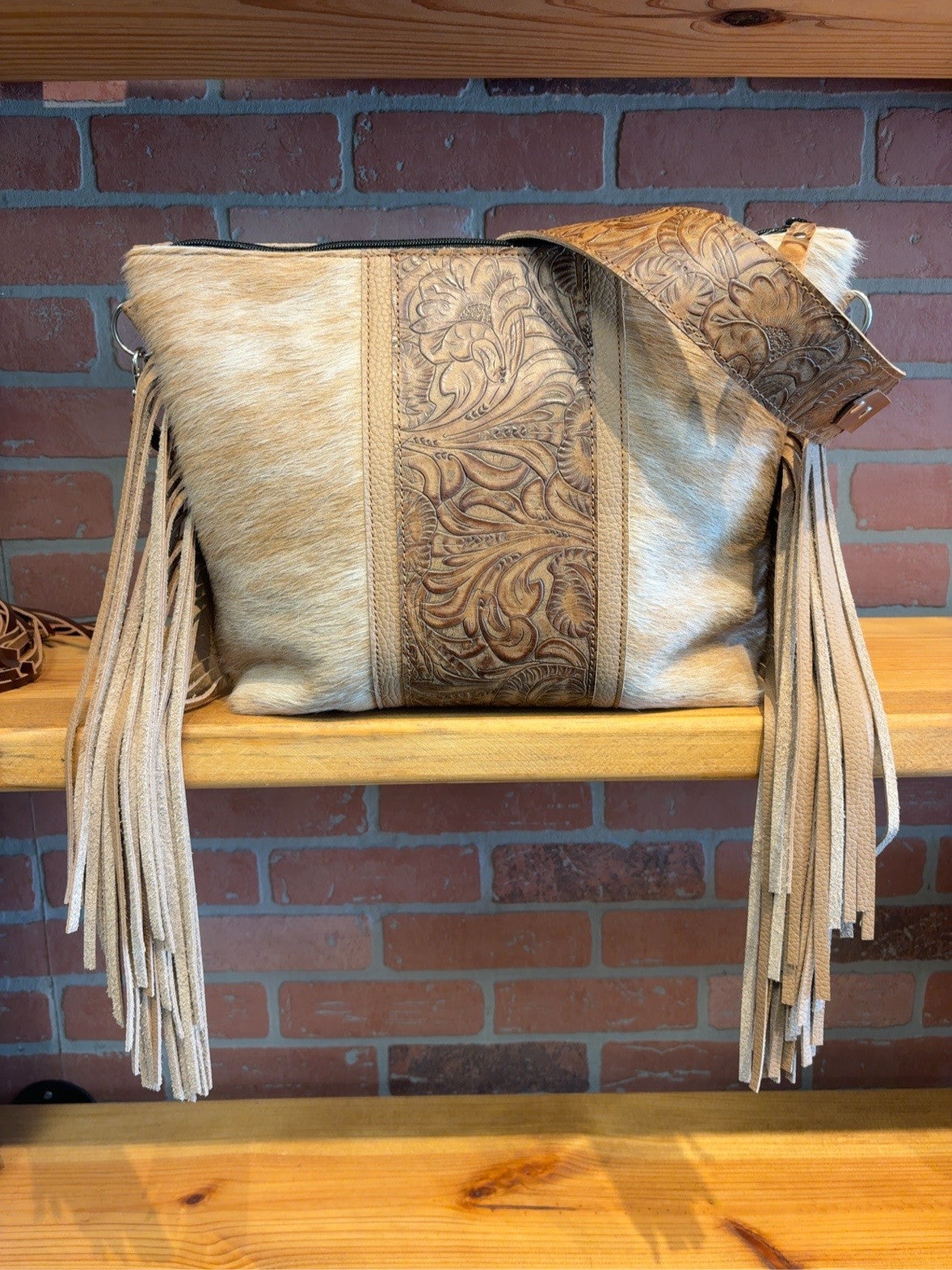 KC bag with tan-and-cream hair-on hide, Honey Floral embossed center and matching shoulder strap, and long tan fringe.