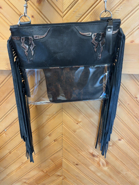 Black Arena crossbody bag with brown-accented longhorn skull detailing, clear lower body, long black fringe, zipper top and pouch