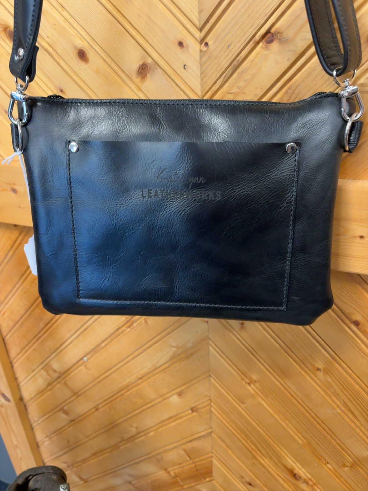 Black back of the Austin bag with a KateLynn Leatherworks rear pocket and silver-tone strap hardware