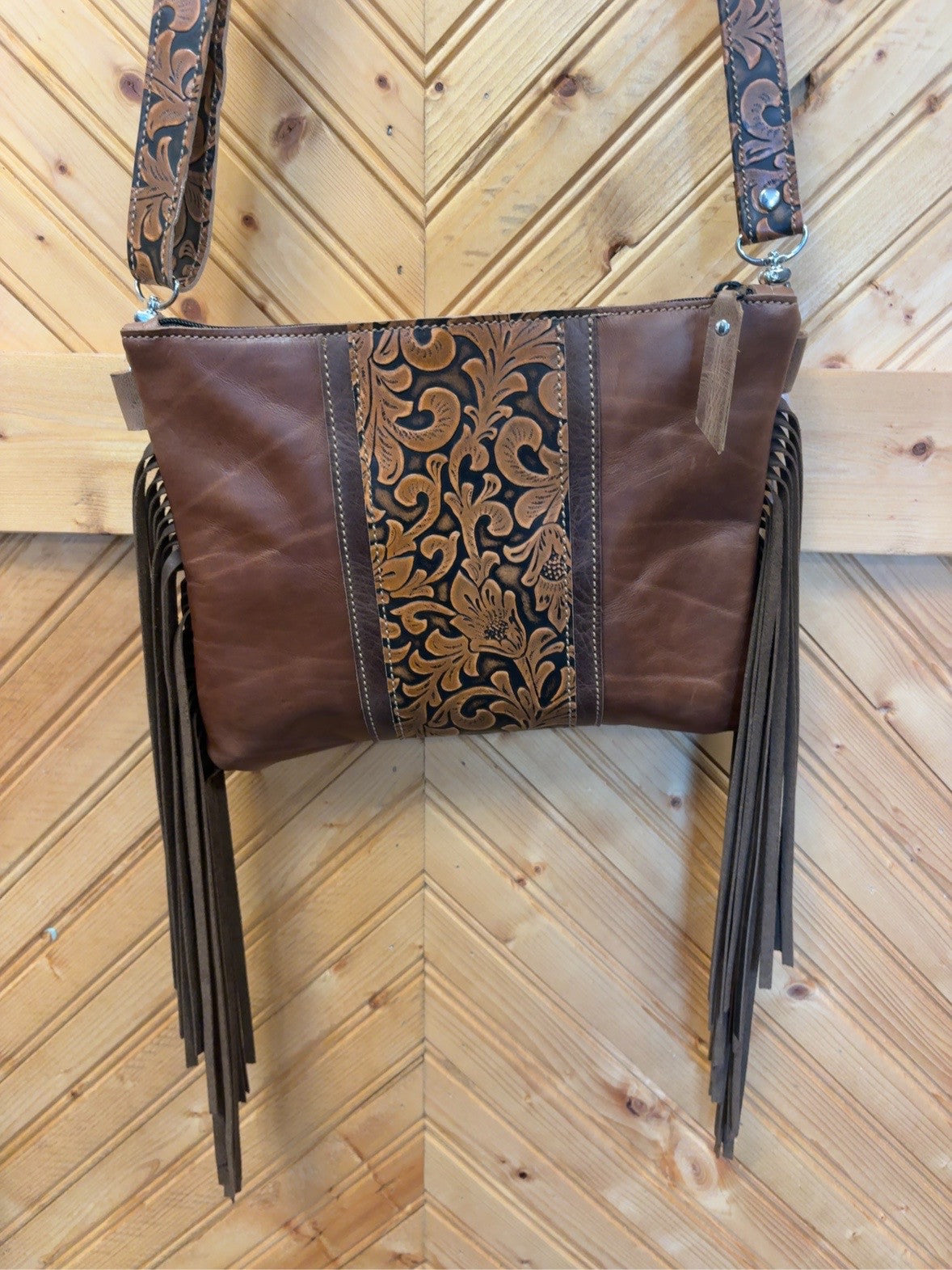 Brown Austin bag with floral embossed leather, matching floral strap and long dark-brown fringe