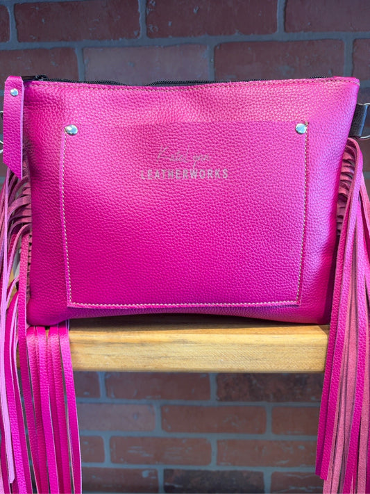 Magenta leather back of Austin bag with exterior slip pocket
