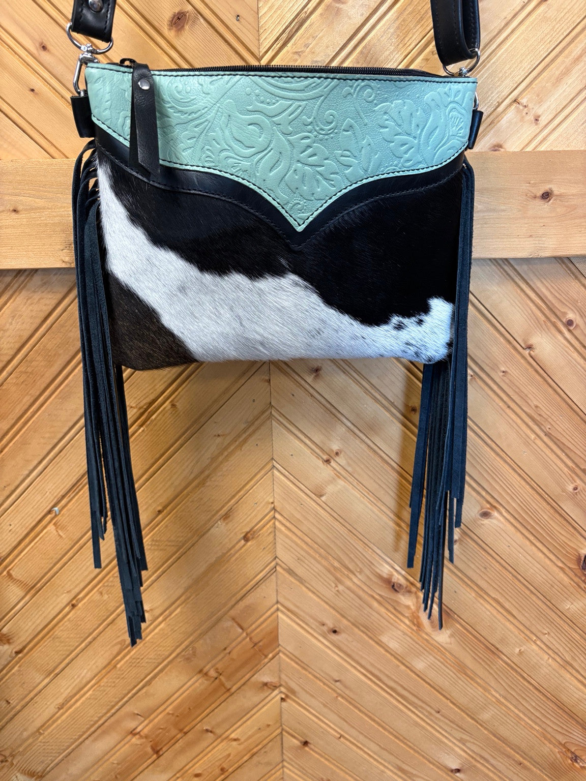 Austin bag with black-and-white cowhide, mint floral embossed leather and black side fringe