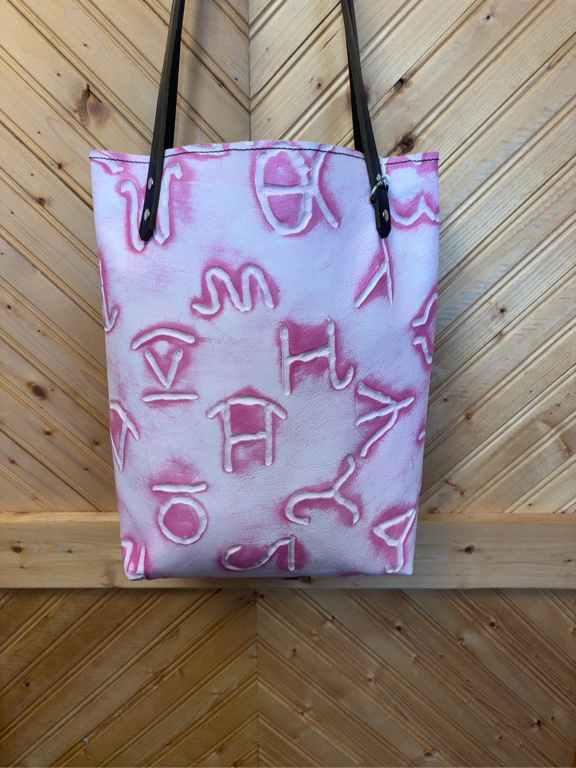 Front of the Pink Barbie Brands Bristow Bookbag with pink-and-white brand motifs, black shoulder straps and silver-tone hardware.