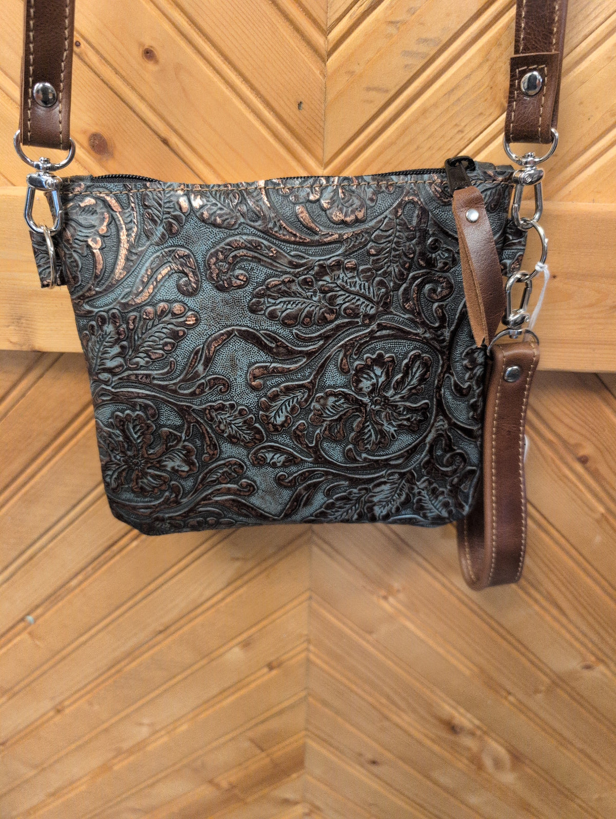 Turquoise and copper-toned floral embossed Purse Sidekick with brown crossbody and wristlet straps