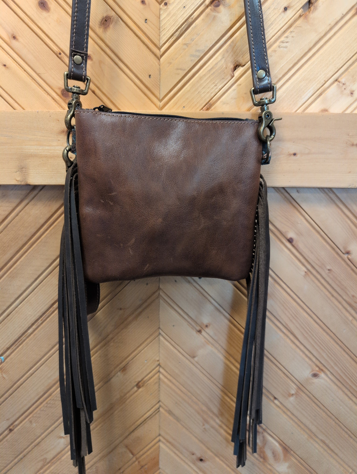Brown back of Purse Sidekick with brown straps, side fringe and zipper-top closure