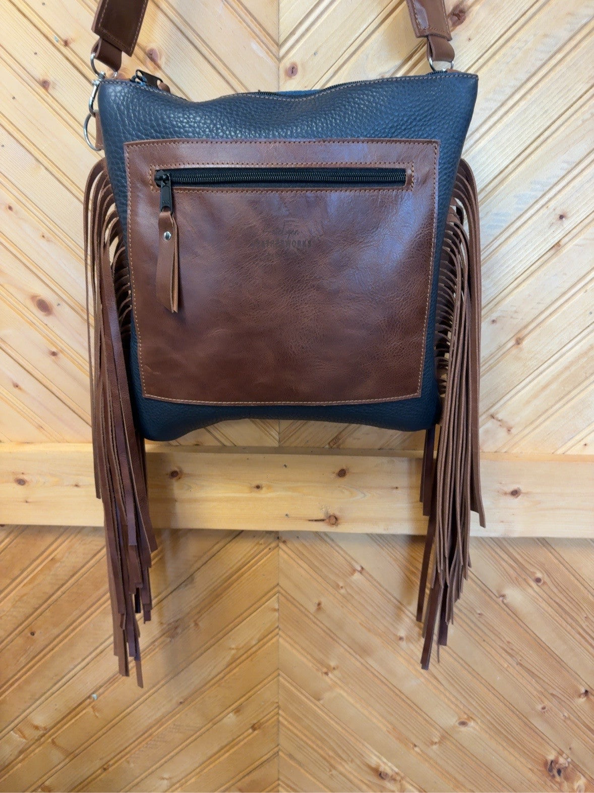 Back of the El Paso bag showing the brown exterior zipper pocket and long side fringe