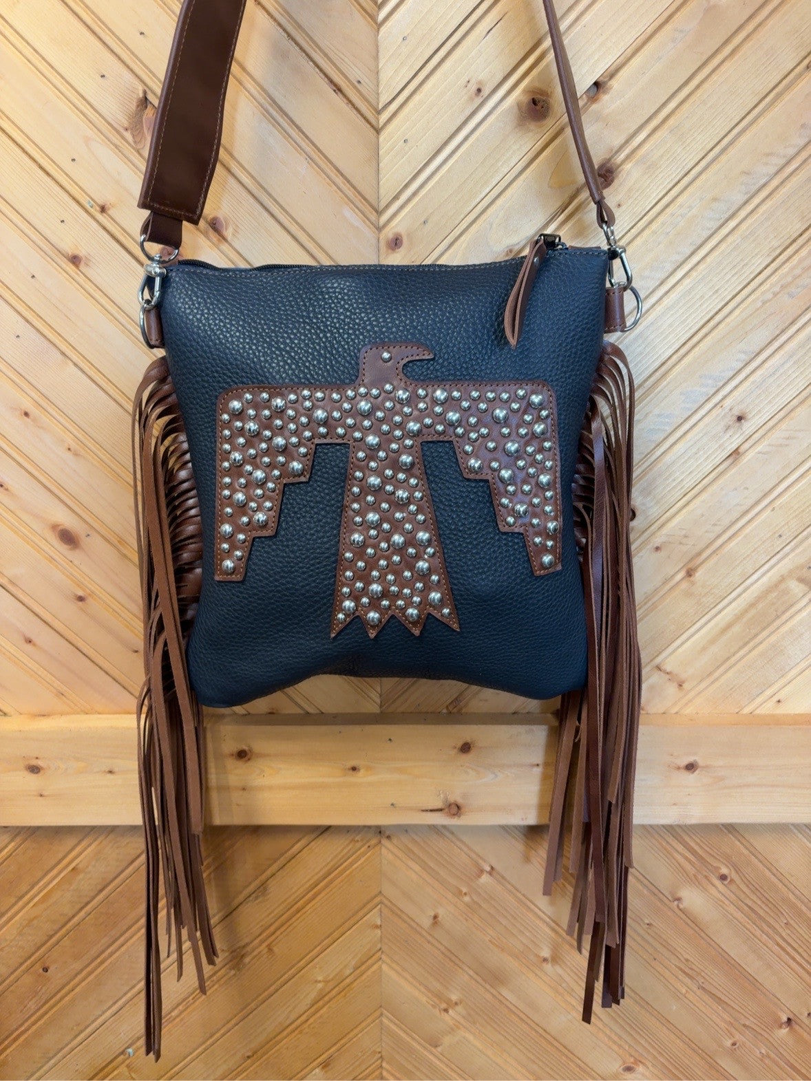 Front of the El Paso bag with a brown Firebird pattern, silver studwork and long brown side fringe