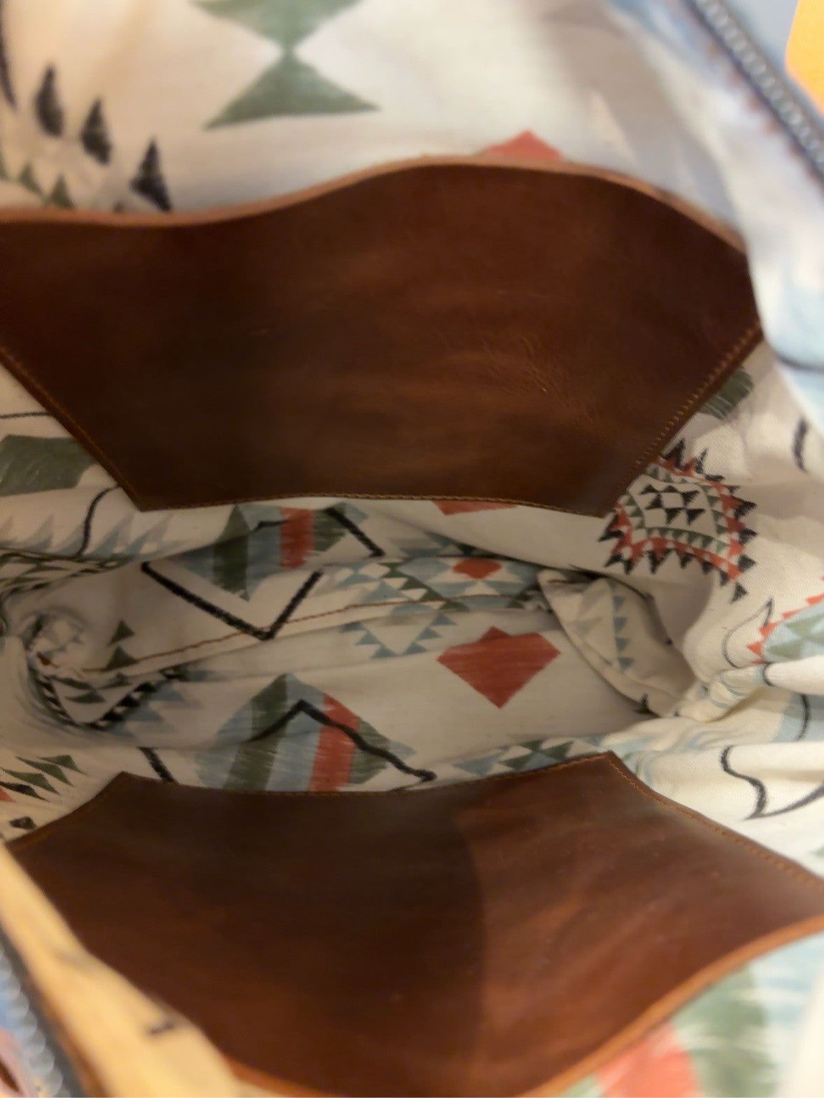 Interior of the El Paso bag showing patterned lining and two brown inside pockets