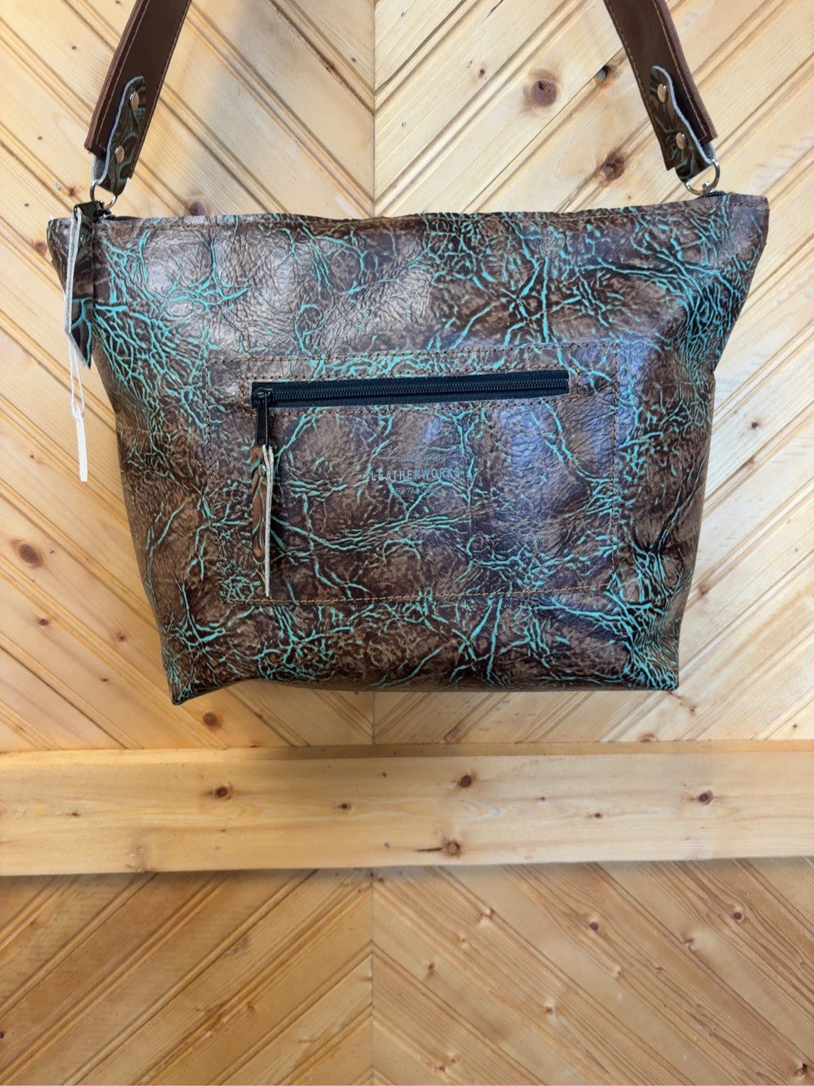 Brown-and-turquoise KC bag back with zipper pocket