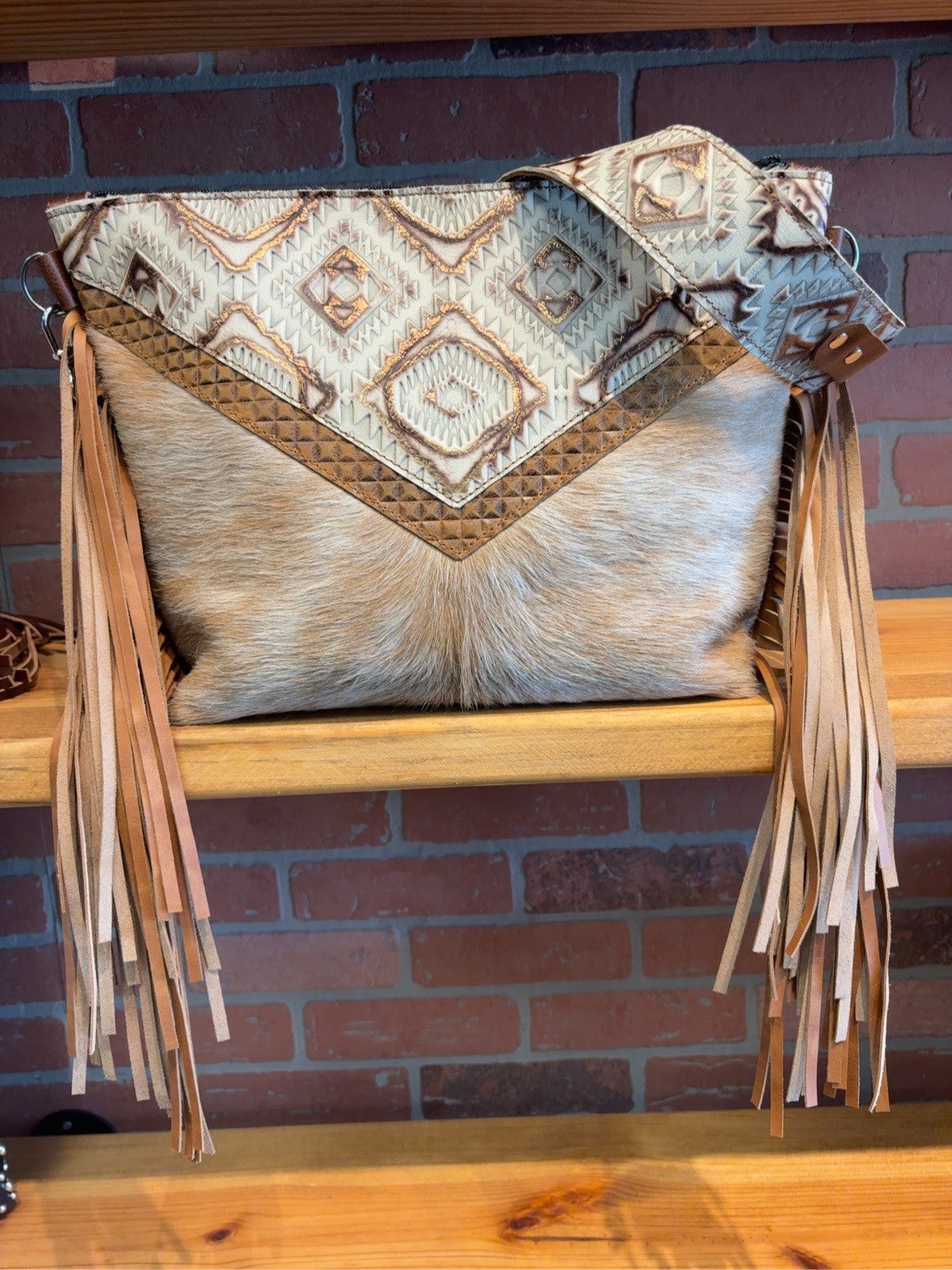 KC bag with Ivory and Copper Aztec embossed detailing, pale tan cowhide front, matching patterned strap and long tan fringe.