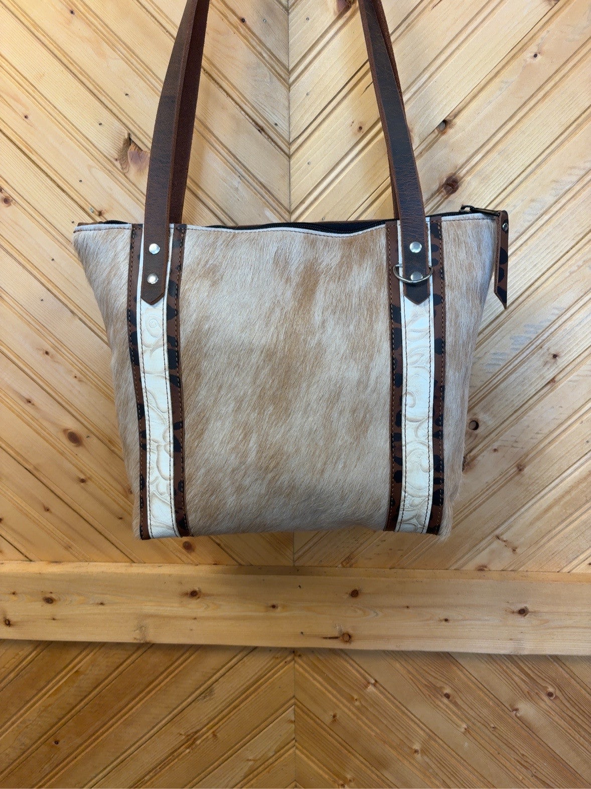 Front of Tucson Mini with light tan cowhide, Ivory Roses embossed strips, leopard-print leather borders and brown shoulder straps