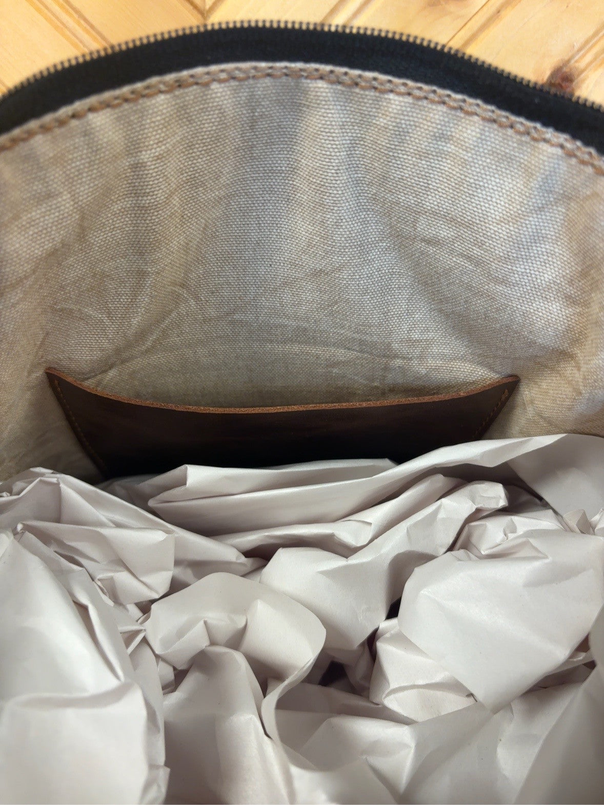 Lined interior of Tucson Mini showing one leather pocket and zipper top