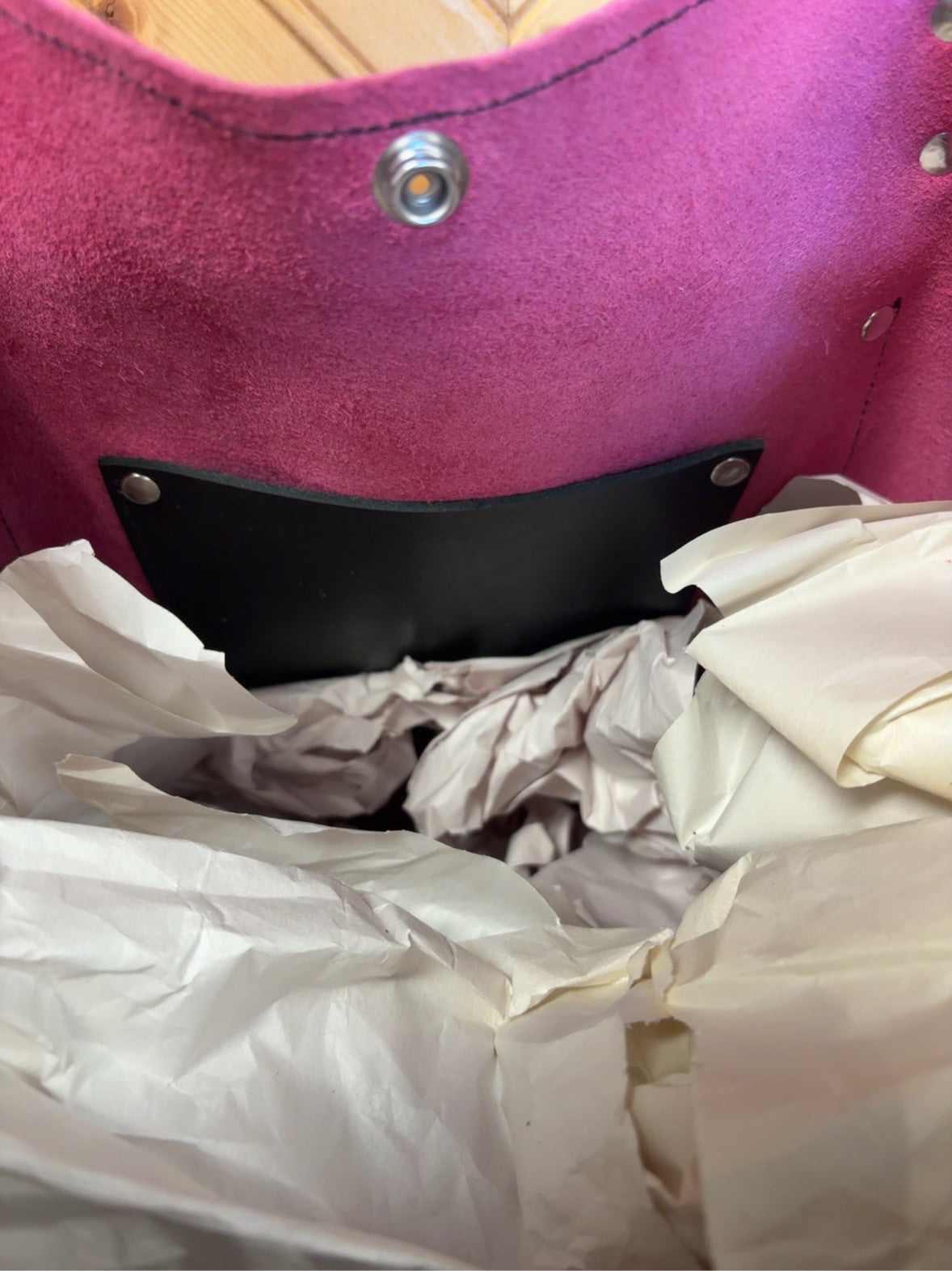 Interior of the Tucson tote showing the snap closure and black inside pocket.