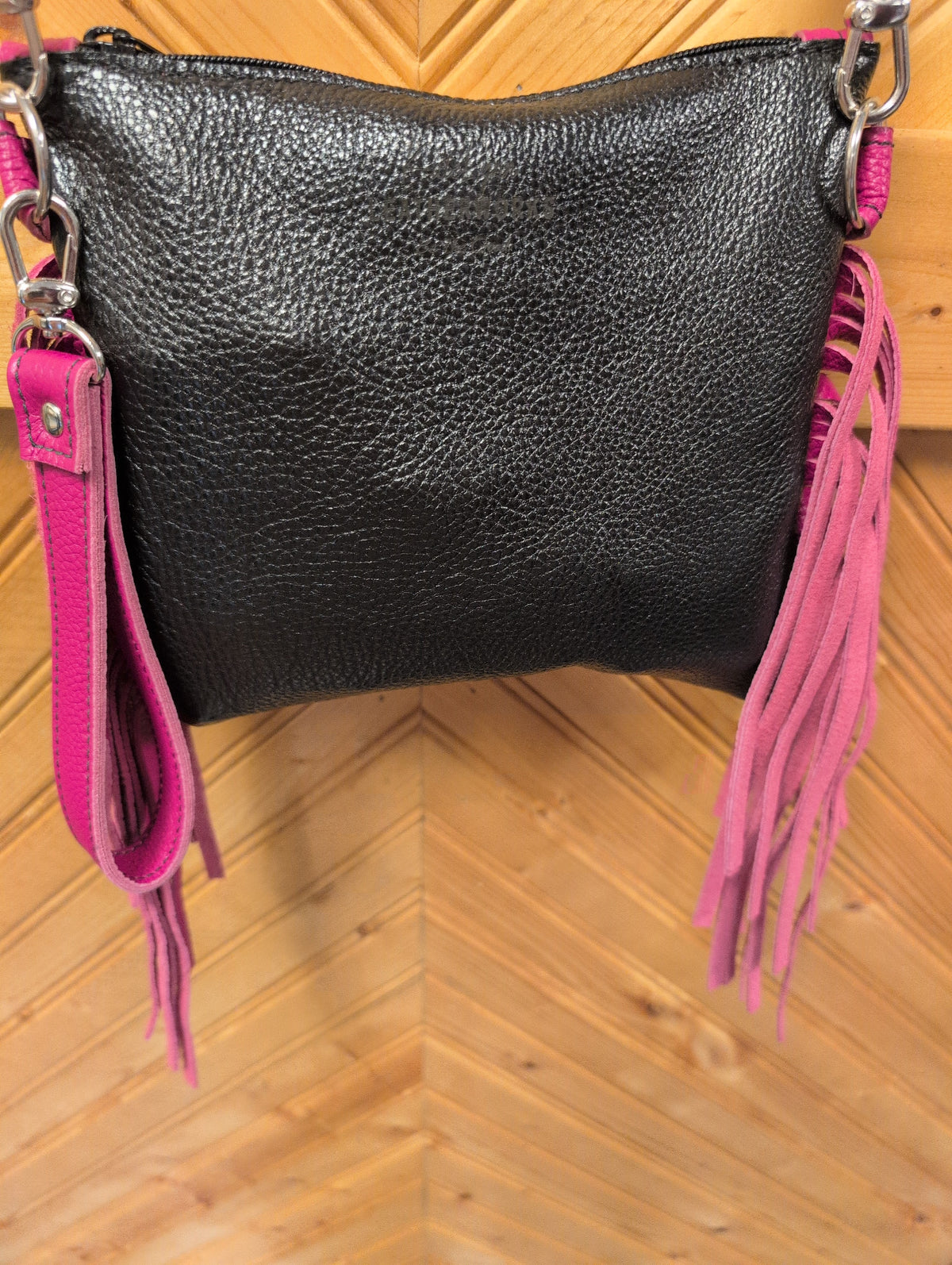 Black back of Purse Sidekick with pink fringe, wristlet strap and zipper closure