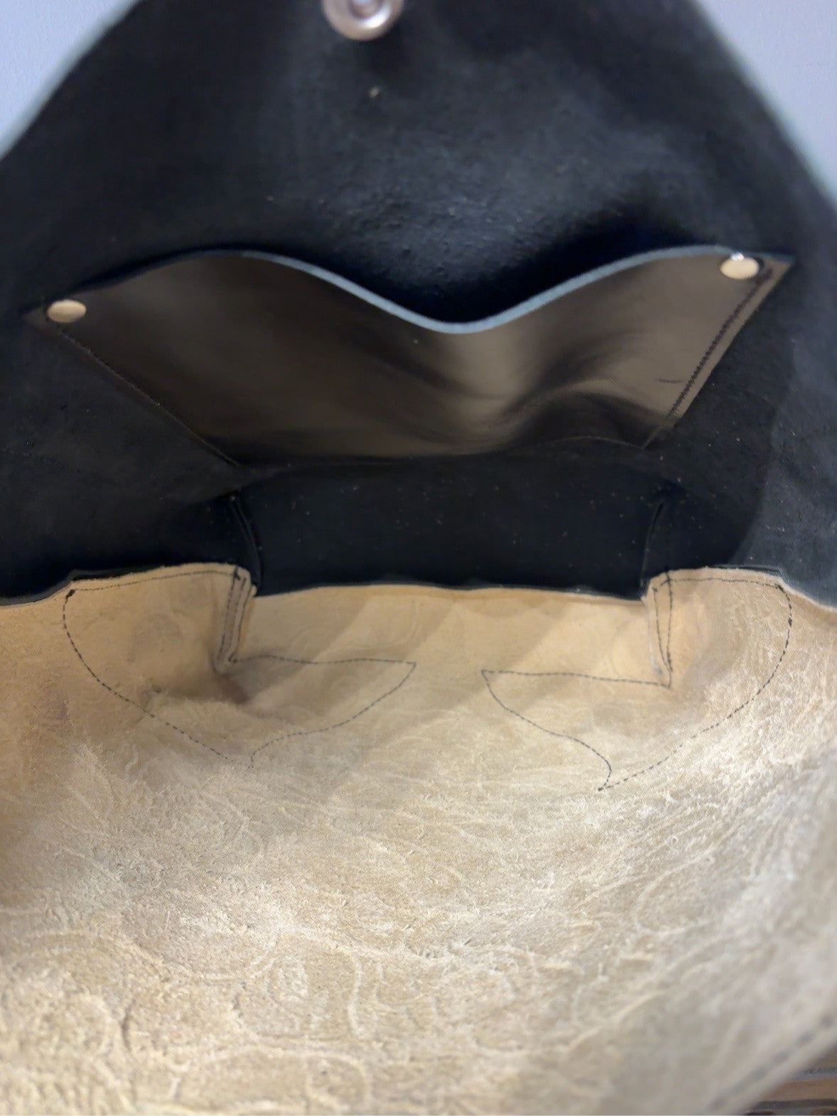 Interior of the Yukon shoulder bag showing one black leather pocket